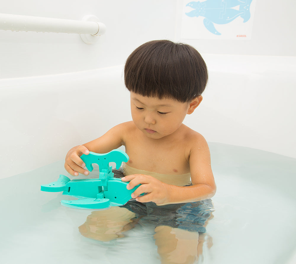 お風呂の水面にフローティックうみがめ/くじらを浮かばせる子供